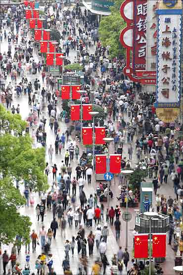 People throng the Nanjing Road shopping district in Shanghai.