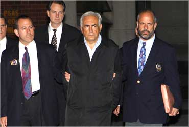 Dominique Strauss-Kahn (C) being escorted from a New York Police Department unit.