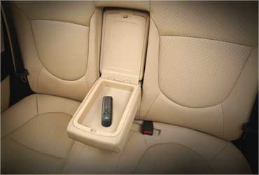 Rear seat armrest with hand audio remote.