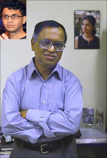 Murthy with photographs of his son and daughter on the wall behind him.
