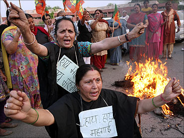 BJP activists shout anti-government slogans during a protest against a recent hike.