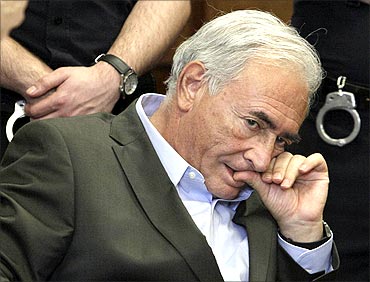 Former IMF chief Dominique Strauss-Kahn listens to his lawyer, Williams Taylor.