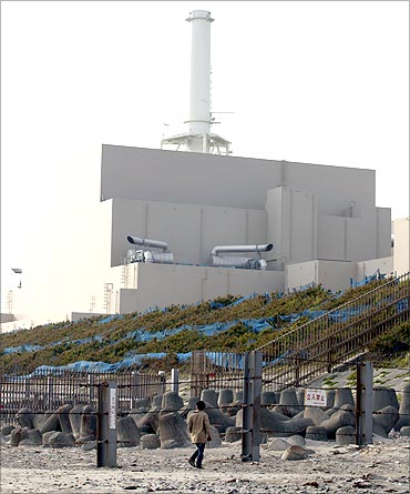 A man looks at Chubu Electric Power's Hamaoka Nuclear Power Station in Omaezaki.