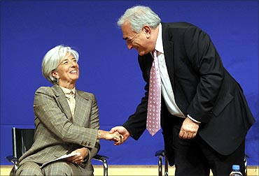 Christine Lagarde (L) shakes hands with Dominique Strauss-Kahn at a conference in June, 2010.
