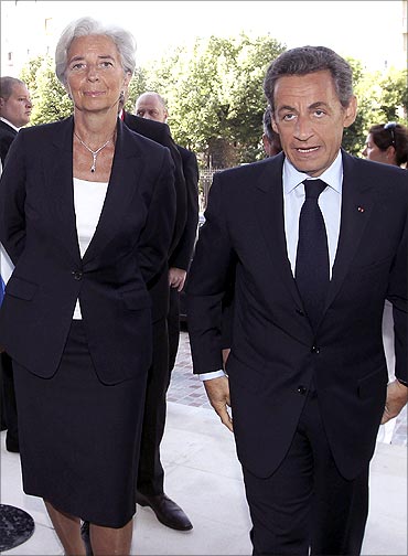 France's Finance and Economy Minister Christine Lagarde (R) chats with French President Sarkozy.