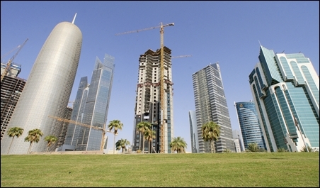 The Doha Office Tower (L) stands next to skyscrapers under construction in Doha.