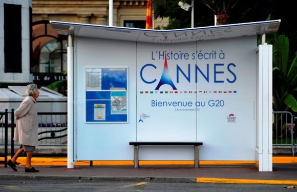 A woman strolls up to a bus stop on the promenade in Cannes, southern France.