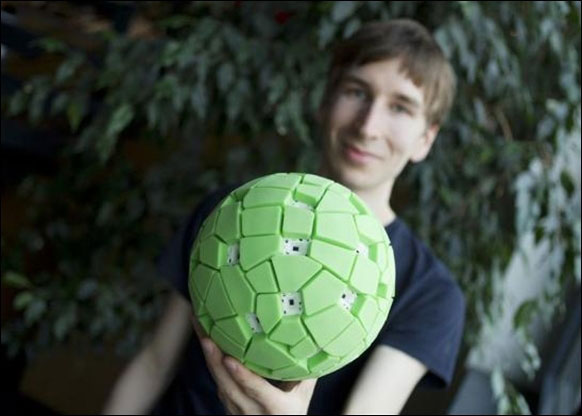 Jonas Pfeil of the Berlin Technical University holds a throwable panoramic ball camera in Berlin.