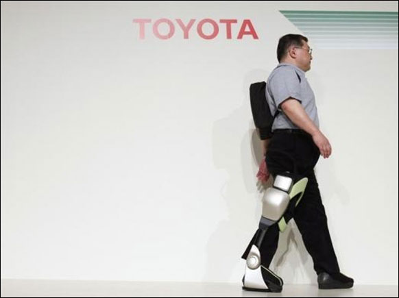 Fujita Health University Professor Eiichi Saito, using an 'Independent Walk Assist' robot.