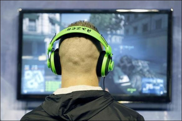 A visitor plays a video game during a visit at the Paris Games Week show in Paris.