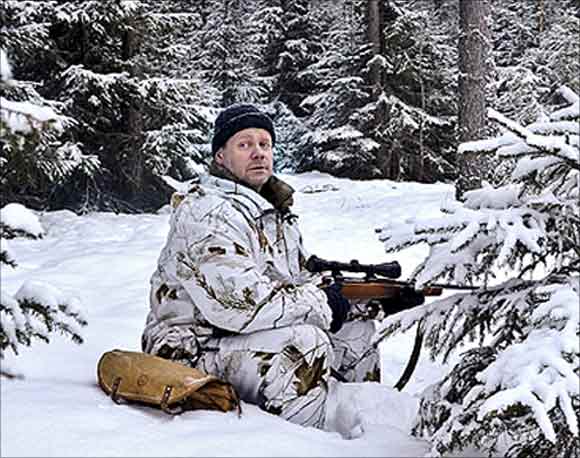 Henrik Widlund looks out during the wolf hunt in Hasselforsreviret, central Sweden.