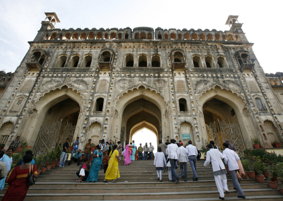 isitors walk towards the main entrance of the Asafi Imambara monument, also known as Bara Imambara, in Lucknow.