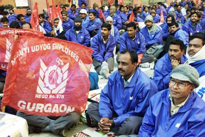 Employees of Maruti Udyog listen to a speaker in New Delhi.
