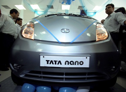 Visitors look at Tata Motors Nano car displayed at show room in Jammu.