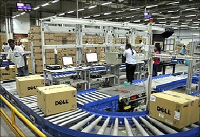 Computers packed into boxes are transported on a conveyor belt at a Dell factory in Sriperumbudur