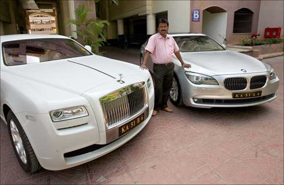 Ramesh Babu with his newly acquired Rolls-Royce and a BMW.