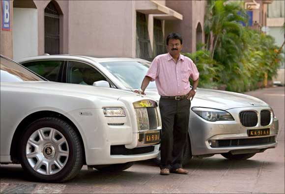 Ramesh Babu with a couple of his luxury cars.