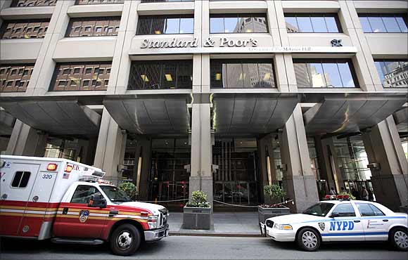 A New York City Fire Department ambulance and a New York Police car are seen parked in front of The Standard and Poor's building in New York.