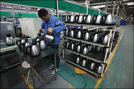 A Galanz employee tests electric kettles at a production line in a factory in Zhongshan.