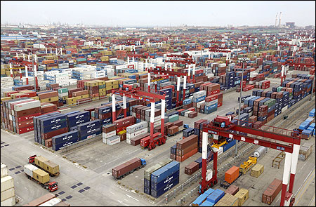 Trucks are driven into a shipping container area at Qingdao port, Shandong.