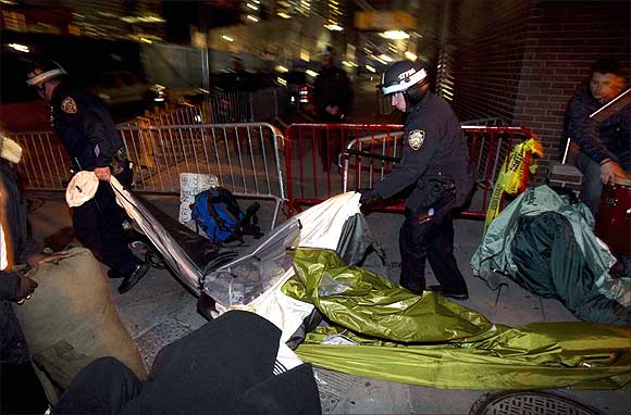 New York Police Department officers remove the belongings of members of the Occupy Wall Street movement after removing members of the movement from Zuccotti Park in New York.