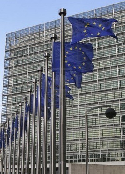 European flags waving in the wind, before the European Commission Berlaymont building in Brussels, Belgium