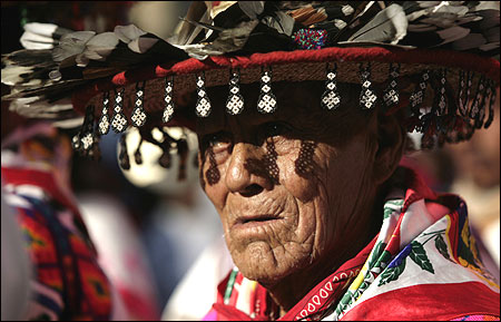 A Huichol elder, wearing a traditional hat, takes part in a protest in Mexico City.