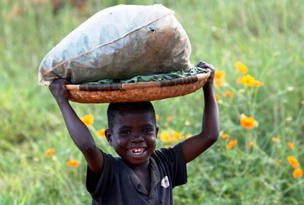 A Malawian child carries a basket outside during a visit by pop star Madonna to the Home of Hope orphanage in Mchinji.