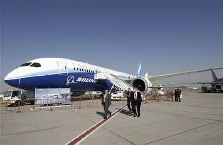 Visitors walk by a Boeing 787-8 Dreamliner during the second day of the Dubai Airshow.