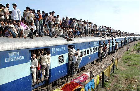 Devotees travel on a crowded passenger train to take part in the