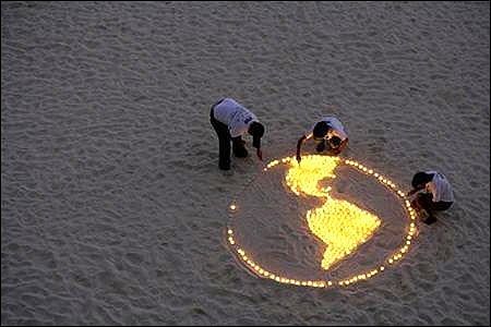 World Wildlife Fund activists light candles representing the earth.