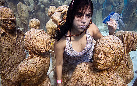 Greenpeace and 350.org stage an underwater installation called 'Silent Evolution' in Cancun.