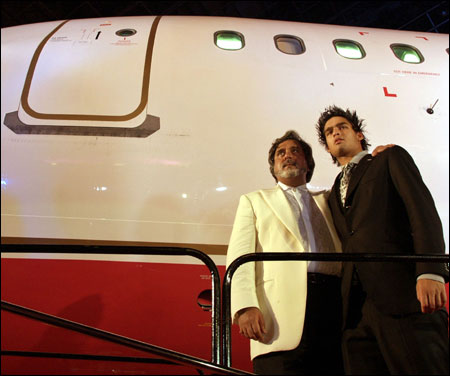 Mallya poses with his son Siddhartha during the launch of Kingfisher Airline in Mumbai on May 7, 2005.
