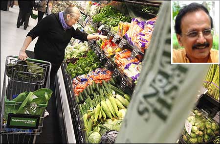 A shopper looks through the produce section in a Walmart Neighborhood Market in Chicago. (Inset) Devinder Sharma.