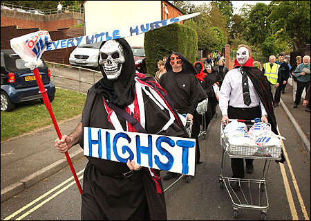 Protestors, dressed as dead shoppers, demonstrate near the location of a proposed Tesco supermarket in Newport Pagnell, England.