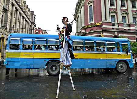 Bablu Das, walks on stilts for an advertisement campaign of an up-coming tourism fair in Kolkata.