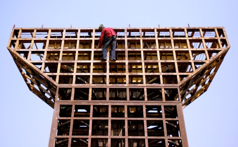 A labourer climbs down from an under-construction pillar of flyover bridge in Mumbai.