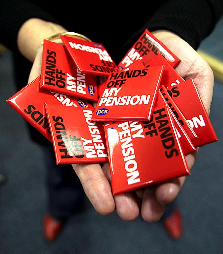 A Public and Commercial Services Union (PCS) member holds badges at at their headquarters in Edinburgh, Scotland.