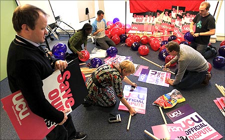 Staff at the University and College Union prepare placards for the November 30 public sector strike, at their offices in Camden, north London.