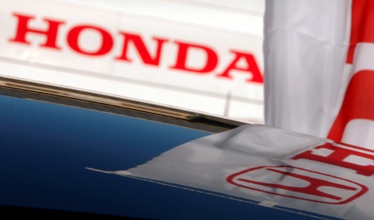 A Honda Motor logo is reflected on the roof of a car in Kawasaki, south of Tokyo.