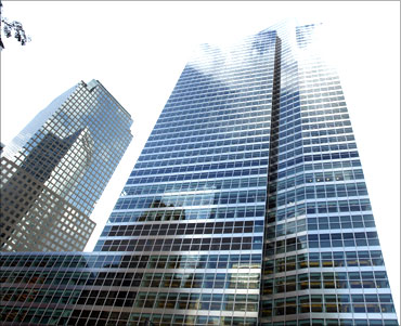 Clouds are reflected on the outside of the Goldman Sachs building.