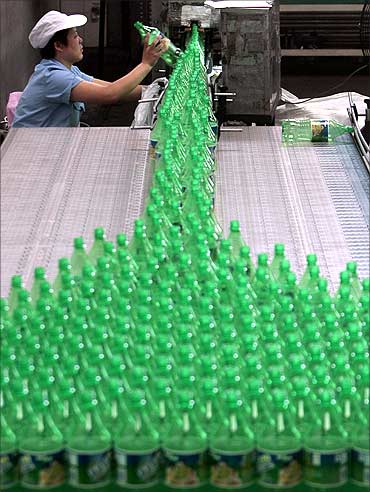 An employee works at a Sprite production line at the Coca Cola plant in Nanjing, Jiangsu province.