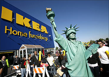 A woman dressed as the Statue of Liberty attends the grand opening of the Ikea home furnishing store.