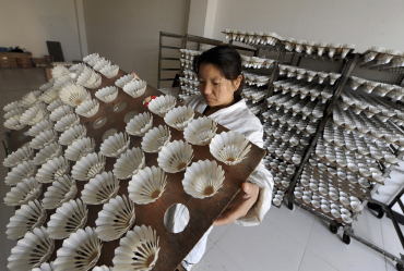 An employee dries shuttlecocks on shelves in Wuhu, Anhui province.