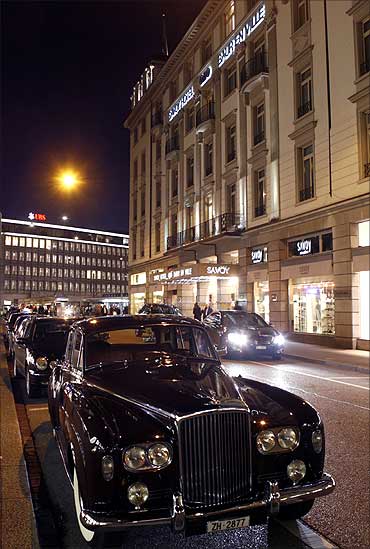 A vintage Bentley limousine is parked in front of the Savoy Hotel Baur En Ville in Zurich.