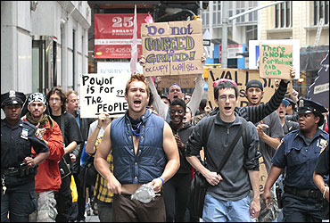 Protesters from the Occupy Wall Street campaign march in front of the New York Stock Exchange.