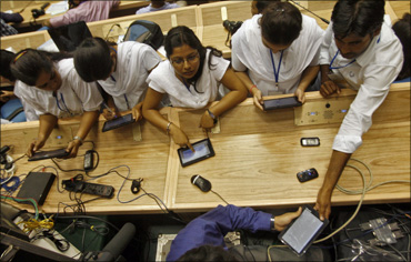 Students use Aakash, which means 'sky', dubbed the world's cheapest tablet computer, after its launching ceremony in New Delhi on October 5, 2011.