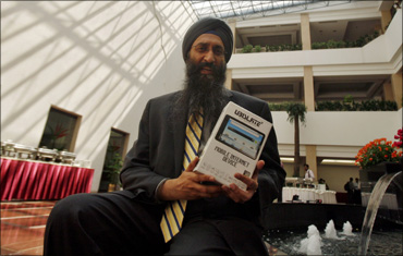 Suneet Singh Tuli, CEO of DataWind, the small British-based company that developed Aakash, displays the 'world's cheapest' tablet during its launch ceremony in New Delhi.