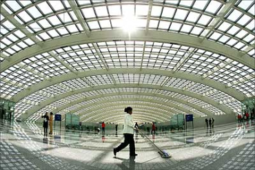 An airport employee cleans the floor at the new terminal building Terminal Three - T3 - at the Beijing Capital International Airport. This is the world's largest terminal.