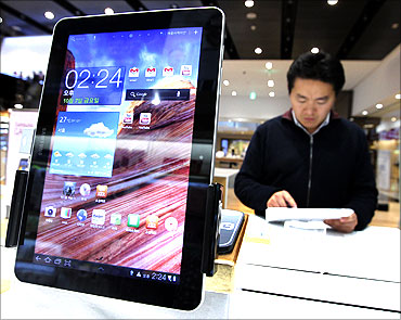 A man uses Samsung Electronics' tablet Galaxy Tab 10.1 displayed for customers.